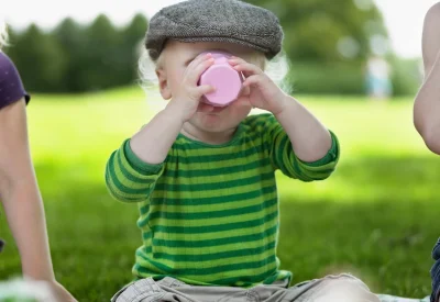 boy-drinking-from-cup-at-picnic-2026-03-11-00-58-09-utc